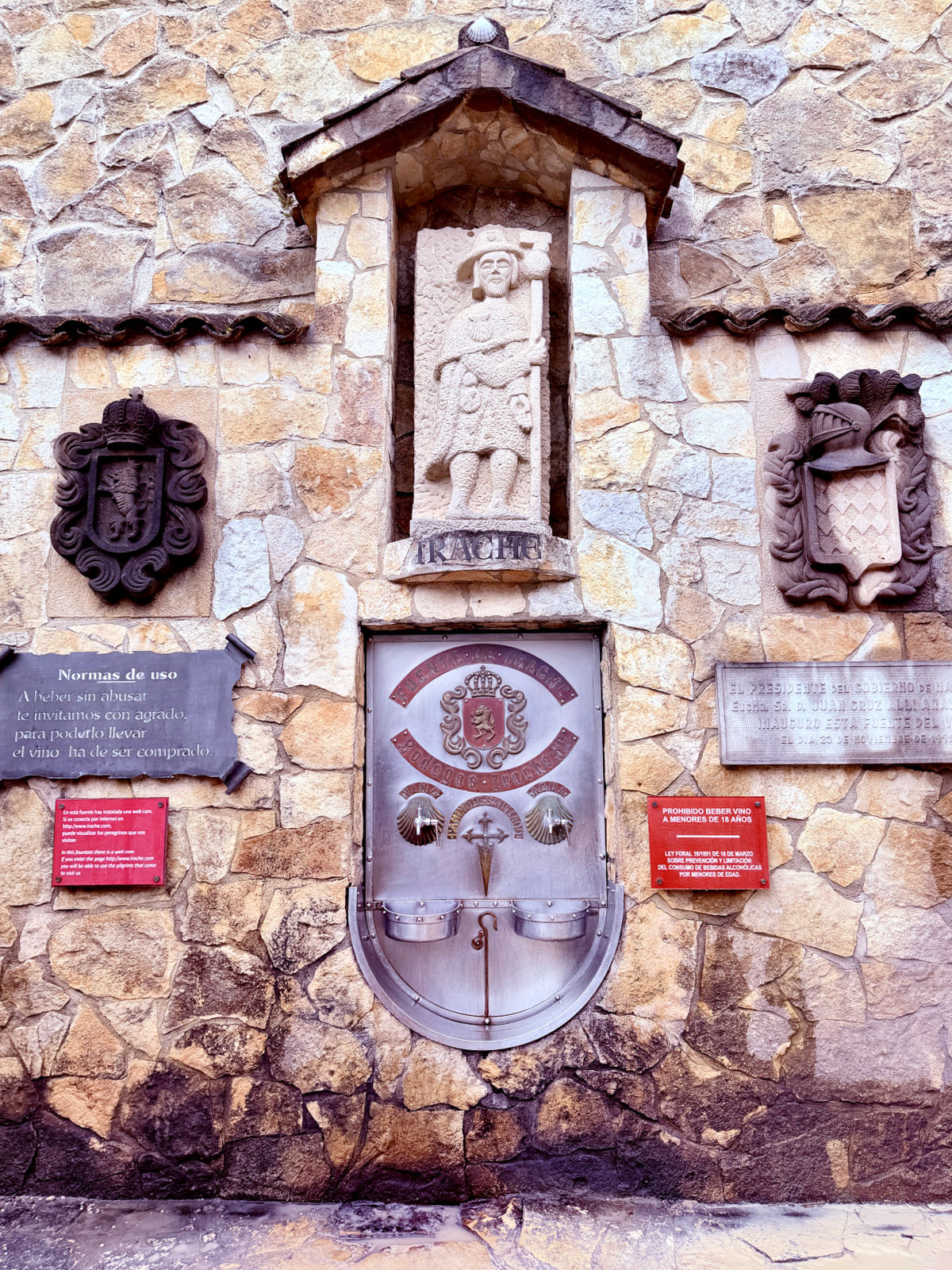 Wine fountain built into the stone wall at Bodegas Irache along the Camino de Santiago.